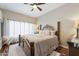 Inviting bedroom with a decorative bed frame, soft lighting, and hardwood floors at 10306 E Rising Sun Pl, Gold Canyon, AZ 85118