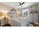 Cozy bedroom featuring a ceiling fan, natural lighting, and warm, neutral decor at 10306 E Rising Sun Pl, Gold Canyon, AZ 85118