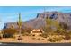 Gold Canyon community sign with mountain views and desert vegetation at 10306 E Rising Sun Pl, Gold Canyon, AZ 85118