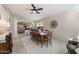 Charming dining room featuring tile flooring, a woven rug, wooden chairs, and an open floor plan at 10306 E Rising Sun Pl, Gold Canyon, AZ 85118