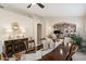 Inviting dining room with a wooden table, stylish decor, and an open archway leading to other living spaces at 10306 E Rising Sun Pl, Gold Canyon, AZ 85118