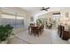 Well-lit dining room featuring a wooden table with seating for six, large windows, and stylish décor at 10306 E Rising Sun Pl, Gold Canyon, AZ 85118