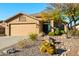 Charming single-story home with a neutral stucco exterior, three-car garage, and a desert-landscaped front yard at 10306 E Rising Sun Pl, Gold Canyon, AZ 85118