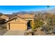 Beautiful home with desert landscaping, mature trees, and two car garage at 10306 E Rising Sun Pl, Gold Canyon, AZ 85118