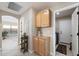 Hallway with storage cabinets and wine rack that leads to the laundry room and bedroom at 10306 E Rising Sun Pl, Gold Canyon, AZ 85118