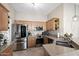 Bright kitchen with stainless steel appliances, wooden cabinetry, and granite countertops at 10306 E Rising Sun Pl, Gold Canyon, AZ 85118