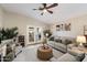 Bright and airy living room with a sofa, chair, and decorative accents at 10306 E Rising Sun Pl, Gold Canyon, AZ 85118