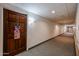 Apartment building hallway with carpet and a wood door at 10330 W Thunderbird Blvd # A321, Sun City, AZ 85351