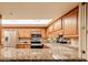 Kitchen with granite countertops and wood cabinets at 10330 W Thunderbird Blvd # A321, Sun City, AZ 85351