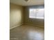 Simple bedroom with tile flooring and a window with blinds at 10365 W Pinehurst Dr, Sun City, AZ 85351