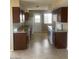 Galley kitchen with granite countertops and dark brown cabinets at 10365 W Pinehurst Dr, Sun City, AZ 85351