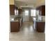 Spacious kitchen with granite countertops and dark wood cabinets at 10365 W Pinehurst Dr, Sun City, AZ 85351