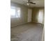 Living room with carpeted floors, a ceiling fan, and a window at 10365 W Pinehurst Dr, Sun City, AZ 85351