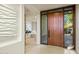 Bright entryway with wood door and view to living area at 10531 E Fernwood Ln, Scottsdale, AZ 85262