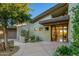 Inviting entryway with a wooden door and desert plants at 10531 E Fernwood Ln, Scottsdale, AZ 85262