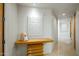 Long hallway with modern artwork and wood console table at 10531 E Fernwood Ln, Scottsdale, AZ 85262