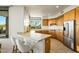 Modern kitchen with light wood cabinets and stainless steel appliances at 10531 E Fernwood Ln, Scottsdale, AZ 85262