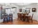 Kitchen with white cabinets, and adjacent dining area with wood table at 10531 W Prairie Hills Cir, Sun City, AZ 85351