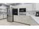 Modern kitchen with stainless steel appliances and white cabinets at 10531 W Prairie Hills Cir, Sun City, AZ 85351