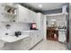 White kitchen with stainless steel appliances and ample counter space at 10531 W Prairie Hills Cir, Sun City, AZ 85351