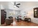 Bright living room with hardwood floors, comfy seating, and large windows at 10531 W Prairie Hills Cir, Sun City, AZ 85351