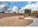 Landscaped backyard with firepit and seating area, perfect for outdoor gatherings at 11259 W Harrison St, Avondale, AZ 85323