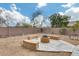 Landscaped backyard with firepit and seating area, perfect for outdoor gatherings at 11259 W Harrison St, Avondale, AZ 85323