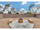 Landscaped backyard with firepit and seating area for outdoor enjoyment at 11259 W Harrison St, Avondale, AZ 85323