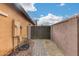 Backyard access with wooden gate and block wall at 11259 W Harrison St, Avondale, AZ 85323