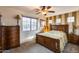 Bedroom with wood furniture, large window and carpet at 11259 W Harrison St, Avondale, AZ 85323