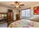 Bedroom with wood furniture, large window and carpet at 11259 W Harrison St, Avondale, AZ 85323