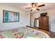 Bedroom with wood furniture, large window and carpet at 11259 W Harrison St, Avondale, AZ 85323