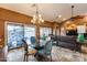 Dining area with glass table, chandelier, and pool view at 11259 W Harrison St, Avondale, AZ 85323