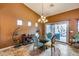 Bright dining room with glass table and access to backyard pool at 11259 W Harrison St, Avondale, AZ 85323