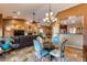 Open dining area with glass table and living room view at 11259 W Harrison St, Avondale, AZ 85323