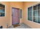 Exterior front entrance with a purple door, and a welcoming mat at 11259 W Harrison St, Avondale, AZ 85323