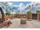 Spacious front patio with brick paving, water feature, and desert landscaping at 11259 W Harrison St, Avondale, AZ 85323