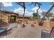 Landscaped front patio with brick paving, a water feature, and mature trees at 11259 W Harrison St, Avondale, AZ 85323