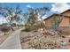 House with a landscaped front yard, a walkway, and a small bridge over a dry creek bed at 11259 W Harrison St, Avondale, AZ 85323