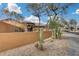 Front yard view of home with mature trees and desert landscaping at 11259 W Harrison St, Avondale, AZ 85323