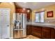 Kitchen corner with stainless steel fridge and wood cabinets at 11259 W Harrison St, Avondale, AZ 85323