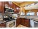 Kitchen with stainless steel appliances and wood cabinets at 11259 W Harrison St, Avondale, AZ 85323