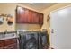 Laundry room with washer, dryer and wood cabinets at 11259 W Harrison St, Avondale, AZ 85323