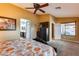 Main bedroom with king bed, ceiling fan, and views of the backyard at 11259 W Harrison St, Avondale, AZ 85323