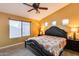 Spacious main bedroom with large windows, a ceiling fan, and ample closet space at 11259 W Harrison St, Avondale, AZ 85323