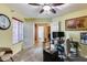 Home office with wood desk and carpet, view of bath at 11259 W Harrison St, Avondale, AZ 85323