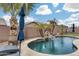 Inviting kidney shaped pool with waterfall feature and lounge chairs at 11259 W Harrison St, Avondale, AZ 85323