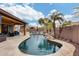 Inviting kidney-shaped pool with a waterfall feature, lounge chairs, and a covered patio at 11259 W Harrison St, Avondale, AZ 85323