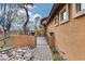 Brick pathway leading to side gate with desert landscaping at 11259 W Harrison St, Avondale, AZ 85323