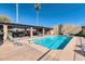 Inviting community pool featuring lounge chairs, tables, and shade creating an ideal space for leisure at 1245 E Avenida Hermosa --, Phoenix, AZ 85014